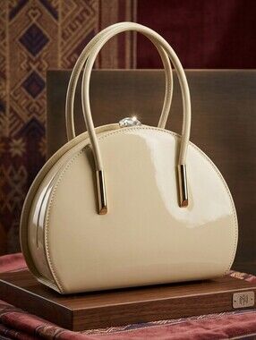 Orli Collection Half Moon Top Handle Dome Handbag Beige Patent Leather